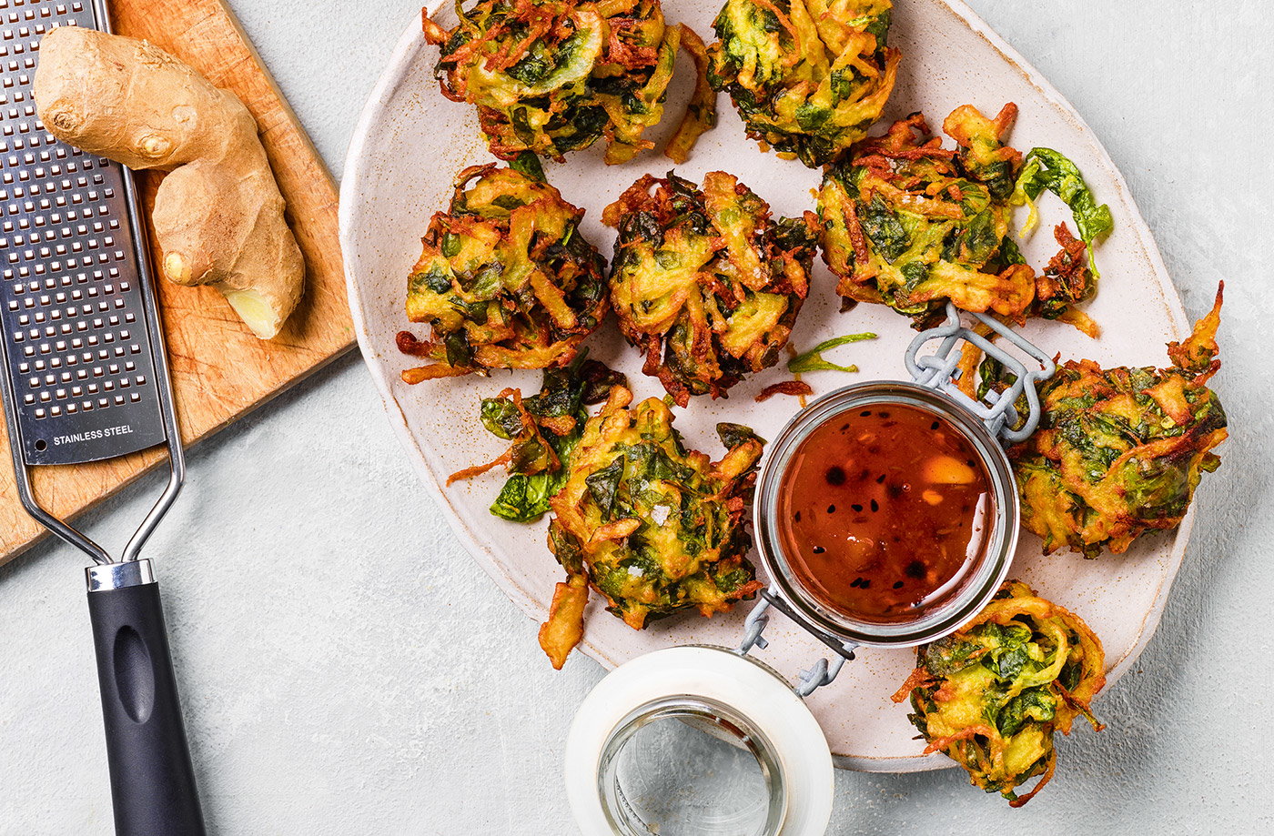 A golden-brown plate of assorted pakoras, showcasing the crispy texture and vibrant colors of the various ingredients.