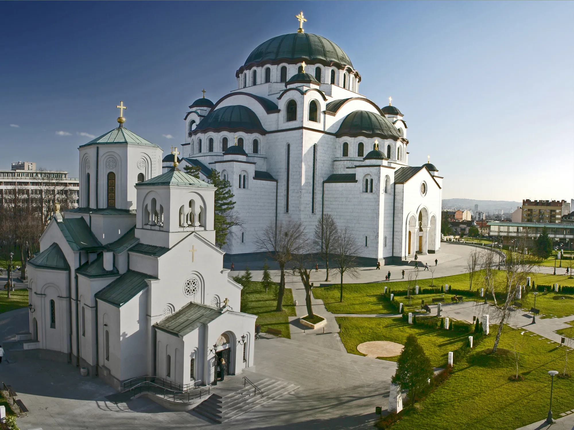 A Serene View Of The Temple Of Saint Sava At Dusk, With Its Golden Dome Illuminated Against The Evening Sky 